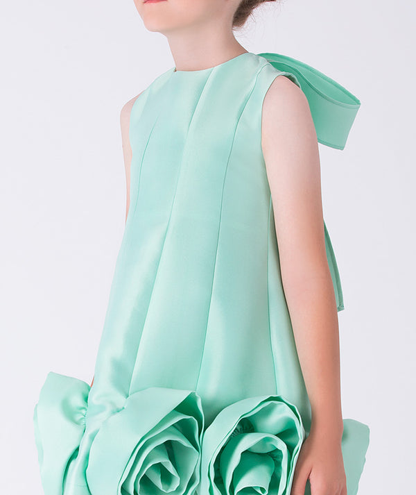 Light green dress with ruffled details on a white background