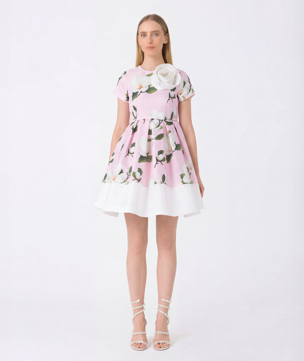 Woman wearing a pink floral dress on a white background