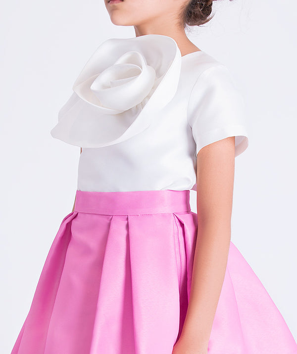 Close-up of sculptural 3D flower detail on a girls two-piece outfit, highlighting refined craftsmanship and modern design.