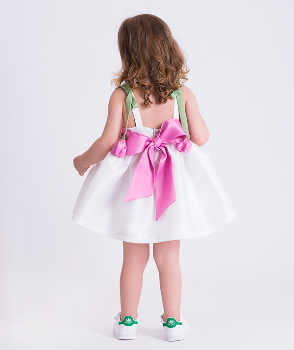 Back view of a baby girl dress with oversized pink bow and wide ribbon straps, designed for elegant celebrations for ages 12–36 months.
