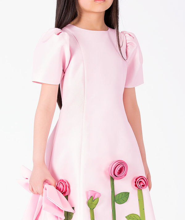 Editorial view of 3D Rose Appliqué Girls Dress in blush pink structured matte satin for girls ages 3 to 12, featuring fabric texture and color