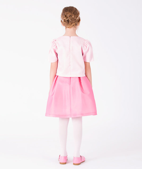Back view of 3D Rose Appliqué Girls Outfit | 2 Pieces in blush pink satin for girls ages 3 to 12, highlighting tailoring, closure and finishing