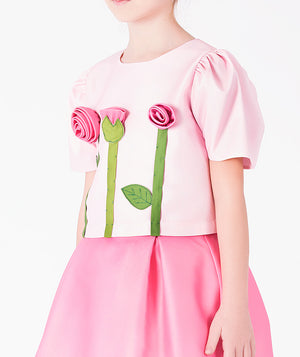 Editorial view of 3D Rose Appliqué Girls Outfit | 2 Pieces in blush pink satin for girls ages 3 to 12, featuring fabric texture and color