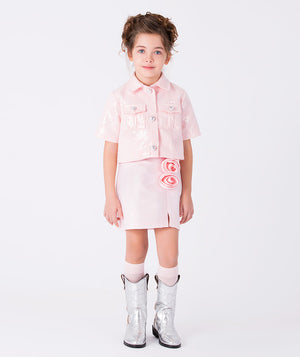 Girl wearing an elegant pink skirt with 3D rose appliqué, styled with a matching jacket for special occasions