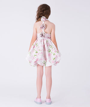 Back view of a flared floral girls dress with open-back rosette details by Mama Luma, ideal for Eid, Easter, and timeless family moments for ages 3–12.