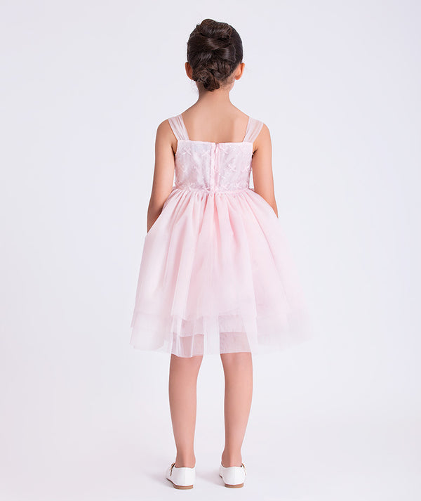 6 years old girl wearing a pink dress on a white background