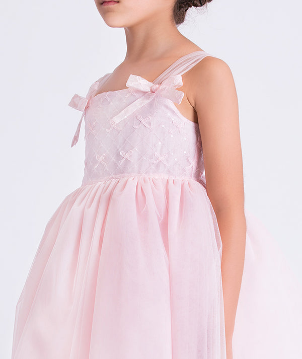 Pink dress with a bow detail on a white background