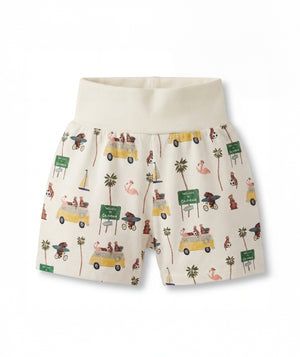 Shorts with a tropical pattern featuring cars, palm trees, and flamingos on a white background.