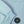 Carica l'immagine nel visualizzatore Galleria, Close-up detail of a light blue girls hoodie highlighting the ribbed sleeve cuff, soft knit fabric, and minimalist chest emblem, designed for everyday wear, school outfits, and casual layering, available in sizes 3–14
