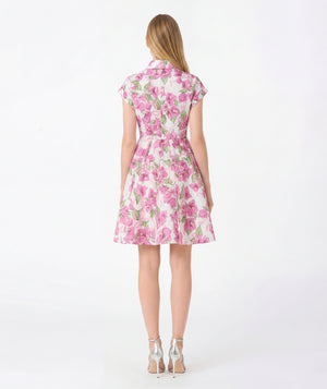 Woman wearing a pink floral dress on a white background