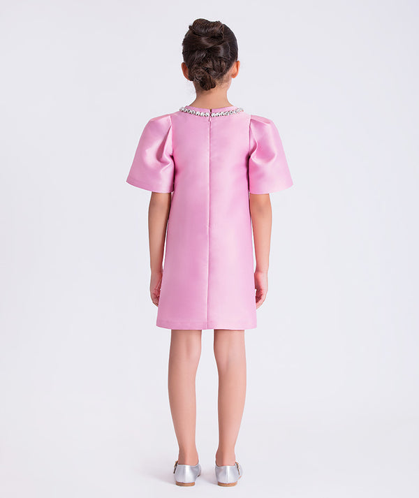 Pink dress with short sleeves and a decorative neckline on a white background