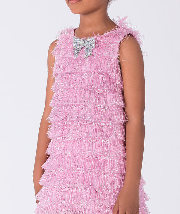 Pink ruffled dress with a silver bow detail on a white background