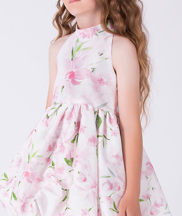 Close-up of the floral print and halter neckline on Mama Luma’s flared girls dress, crafted for refined celebrations and ages 3–12.
