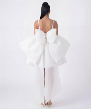 White dress with a large bow detail on a white background