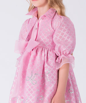 Pink dress with white patterns on a white background