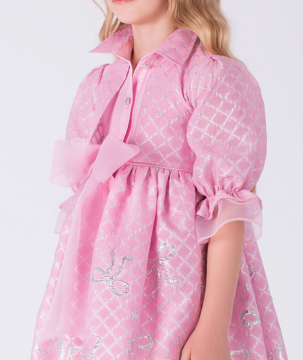 Pink dress with white patterns on a white background