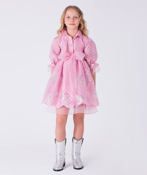 8 years old girl wearing a pink dress with a bow and silver boots on a white background