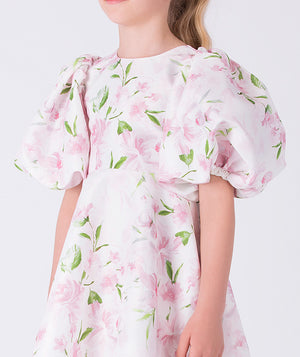 Close-up of the floral fabric and balloon sleeves on Mama Luma’s girls dress, crafted for special occasions and refined comfort for ages 3–12.