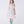 Load image into Gallery viewer, Young girl wearing a floral dress and green boots on a white background
