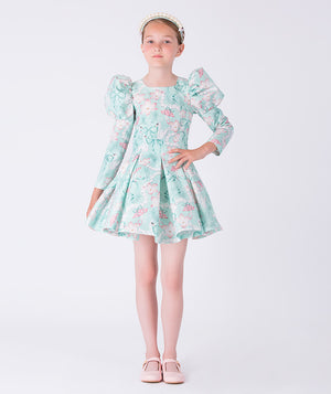 Young girl wearing a floral dress on a white background