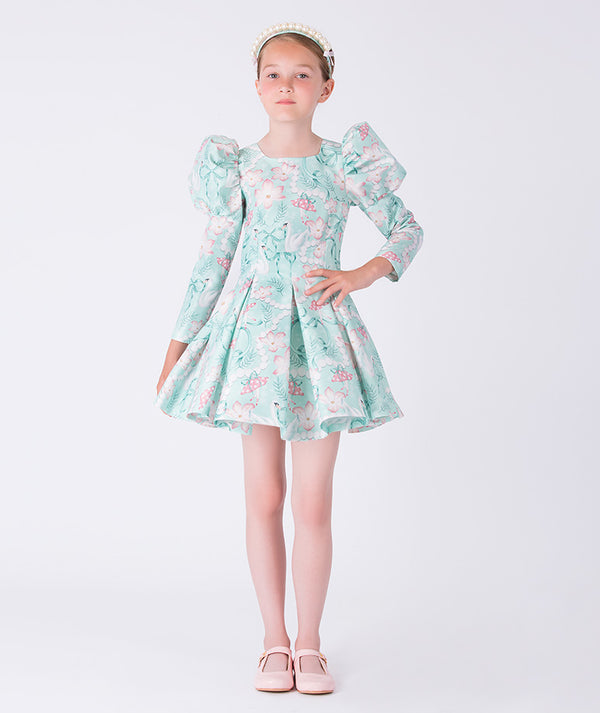 Young girl wearing a floral dress on a white background
