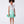 Load image into Gallery viewer, 6 years old girl wearing a light green dress with floral details on a white background
