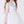 Load image into Gallery viewer, White dress with sheer sleeves and bow details on a white background
