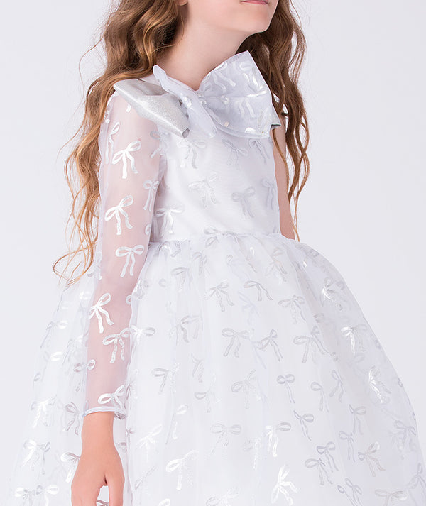 White dress with sheer sleeves and bow details on a white background
