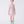 Carica l'immagine nel visualizzatore Galleria, 8 years old girl wearing a light purple dress with a floral pattern and green rain boots on a white background
