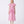 Carica l'immagine nel visualizzatore Galleria, Woman wearing a pink dress with ruffled sleeves on a white background

