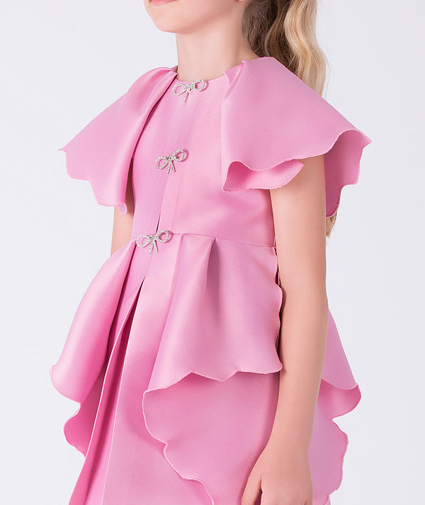 Pink dress with ruffled details on a white background