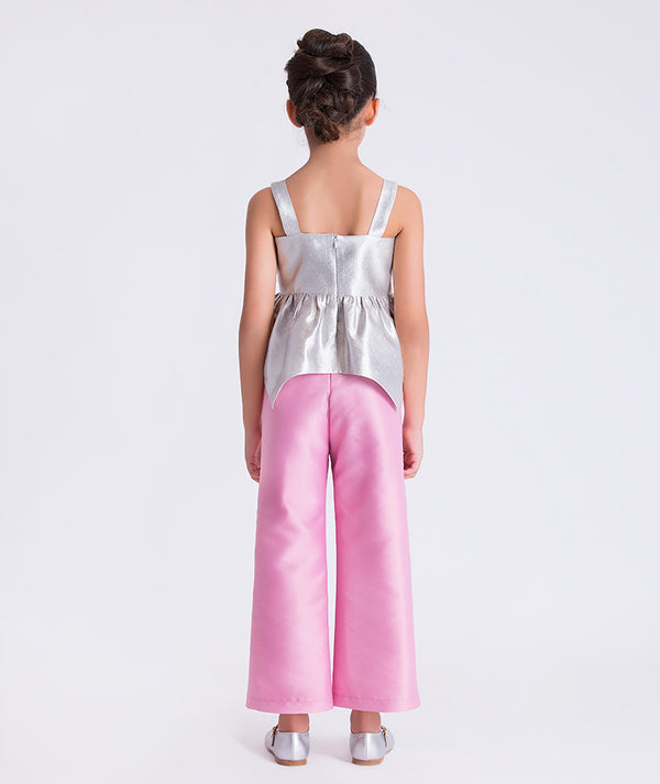 4 years old wearing a silver top and pink pants on a white background