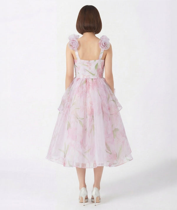 Woman wearing a pink floral dress on a white background