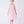 Load image into Gallery viewer, Young girl wearing a pink dress with floral details on a white background
