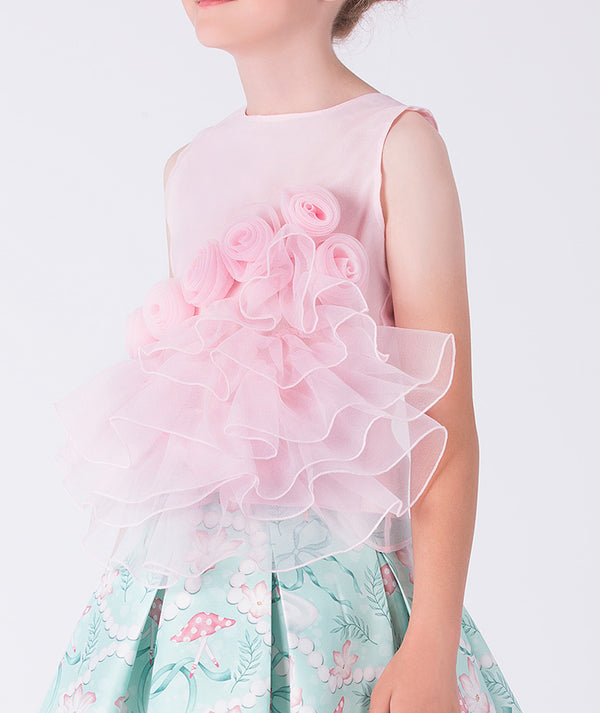 4 years old Child wearing a pink floral top with a light blue skirt featuring pink flowers on a white background