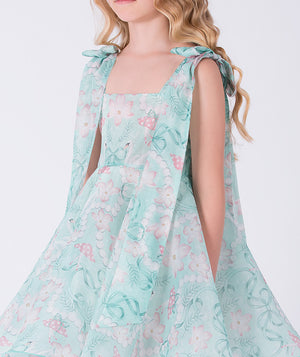 7 years old Girl wearing a floral dress with a white background