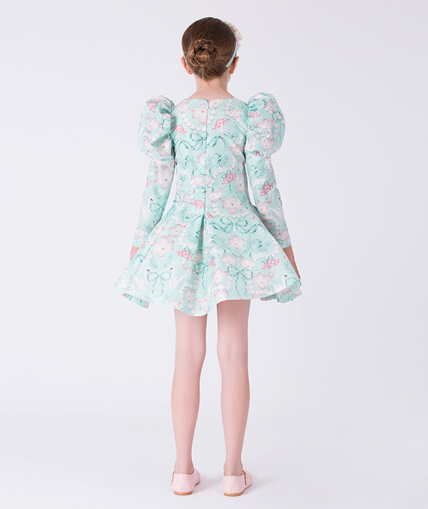 Girl wearing a floral dress with puffed sleeves on a white background