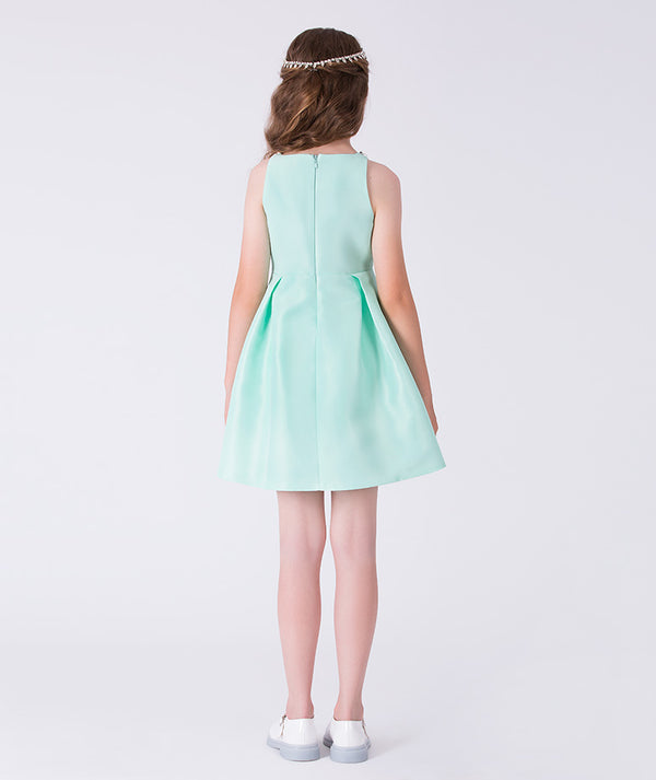Girl wearing a light blue dress on a white background