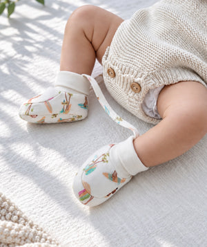 Baby booties in a product photograph, soft infant footwear.