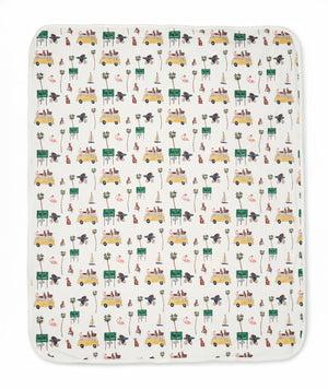 Patterned blanket with vehicles and nature elements on a white background
