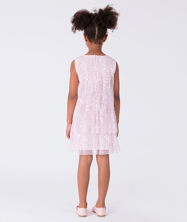 5 years old girl wearing a white sleeveless dress with star patterns on a white background