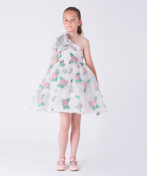 9 YEARS OLD girl wearing a floral one-shoulder dress on a white background