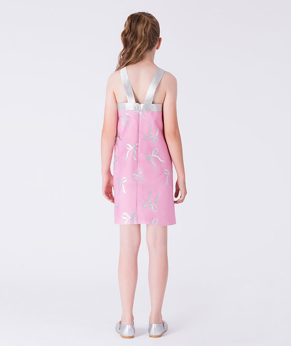 Pink dress with silver bow details on a white background