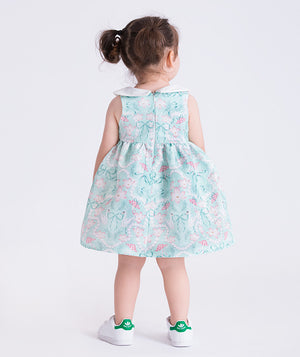 baby girl wearing a floral dress with a plain background