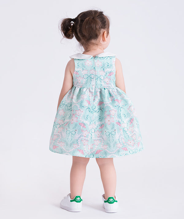 baby girl wearing a floral dress with a plain background