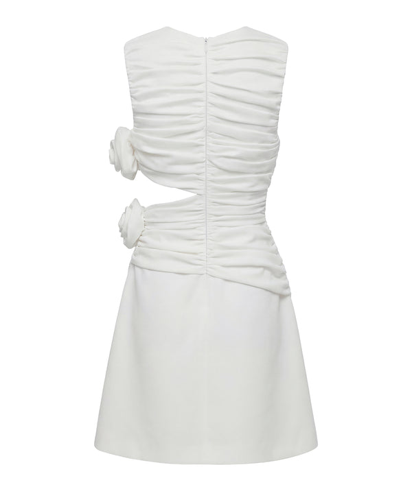 White dress with ruched bodice and bow details on a white background
