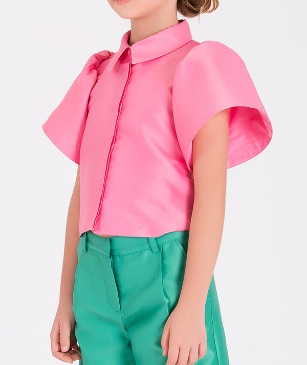 a pink blouse and mint pants