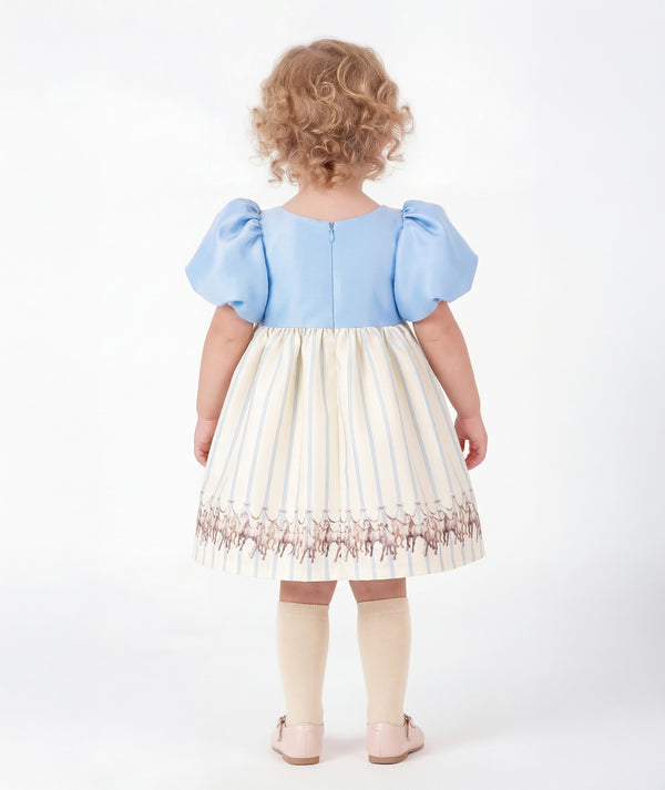 Back view of Altai Morin Baby Girls Dress with baby-blue puff sleeves, ivory striped skirt and equestrian horse detailing by Mama Luma.