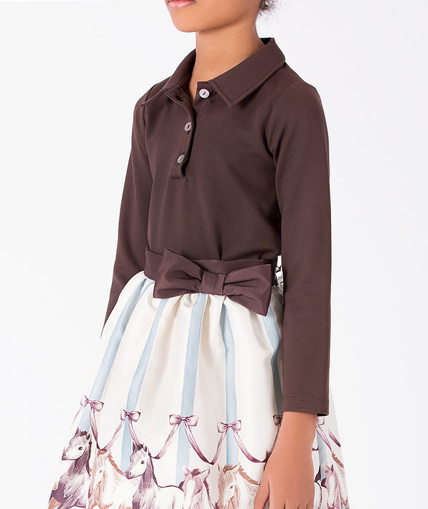 Detail view of Altai Morin Skirt Girls Outfit featuring a chocolate collared top, side bow and illustrated equestrian skirt by Mama Luma.