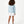 Load image into Gallery viewer, Girl seen from the back wearing a light blue sweatshirt and white shorts, styled for everyday athleisure, school days, and active play, available in sizes 3–14
